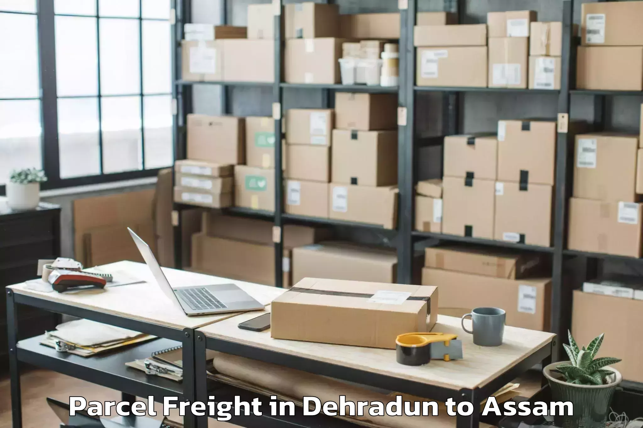 Book Dehradun to Behali Parcel Freight